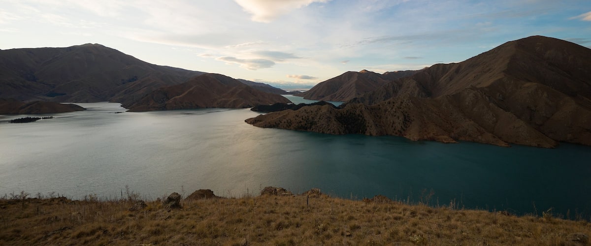 A mountainous landscape with a lake surrounded by hills.