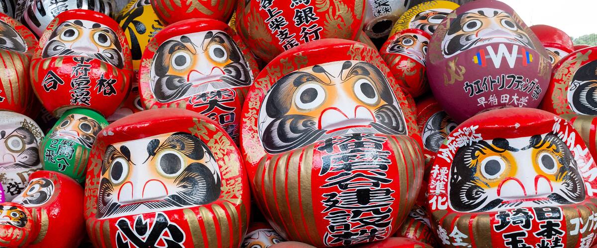 A collection of traditional Japanese dolls with various facial expressions and designs.