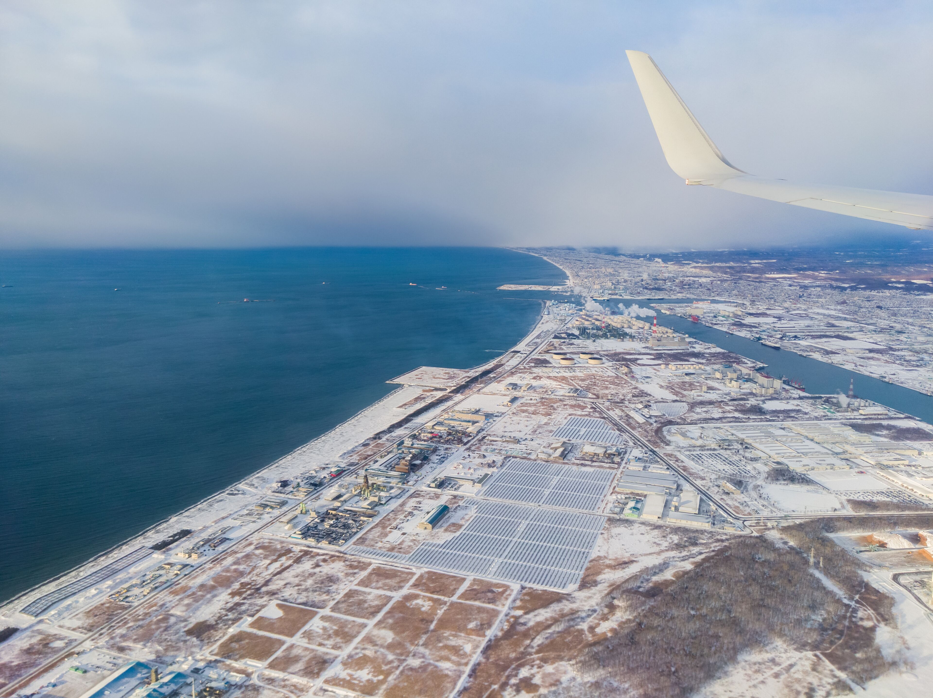 Snow-covered port town seen from the sky (Tomakomai, Hokkaido, Japan)