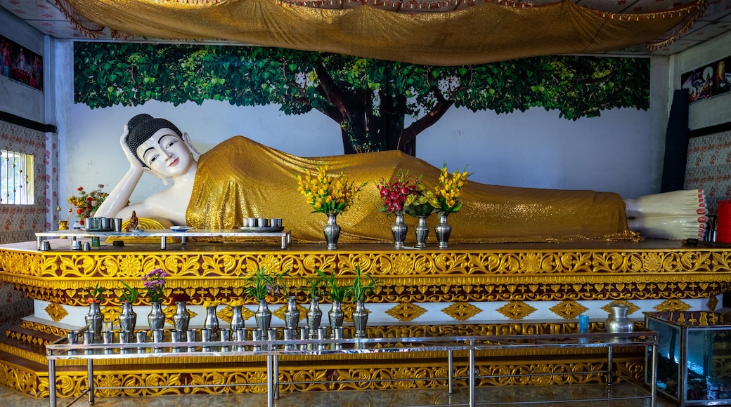 Golden Reclining Buddha Statue Adorned with Flowers at a Buddhist Monastery in Moheskhali Upazila, Cox's Bazar, Bangladesh