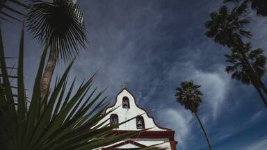 Low angle view of Miraflores Church seen from behinh a palm leave.
East Cape region of Los Cabos