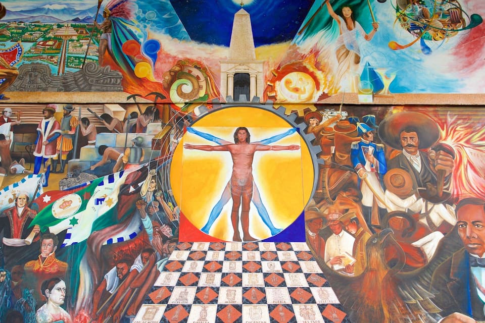 A mural with a central figure, surrounded by various historical and cultural elements.