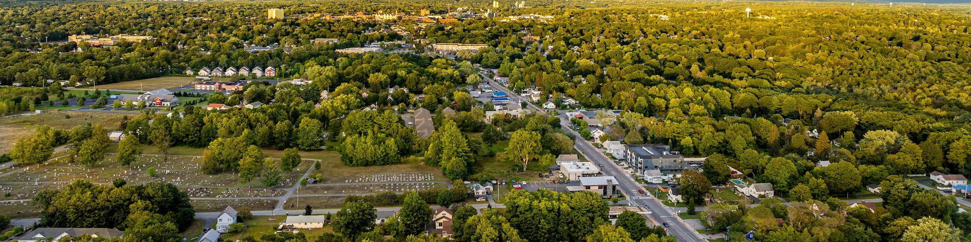 Queensbury, NY, USA - August 27, 2025: Late afternoon aerial view over the Queensbury / Glens Falls area near the southern boundary of the Adirondack Park of of Interstate 87.
