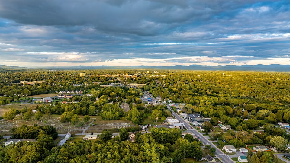 Queensbury, NY, USA - August 27, 2025: Late afternoon aerial view over the Queensbury / Glens Falls area near the southern boundary of the Adirondack Park of of Interstate 87.