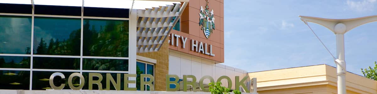 A building with a sign that reads "CITY HALL" and "CORNER BROOK".