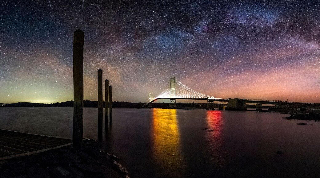 Milky way over illuminated bridge