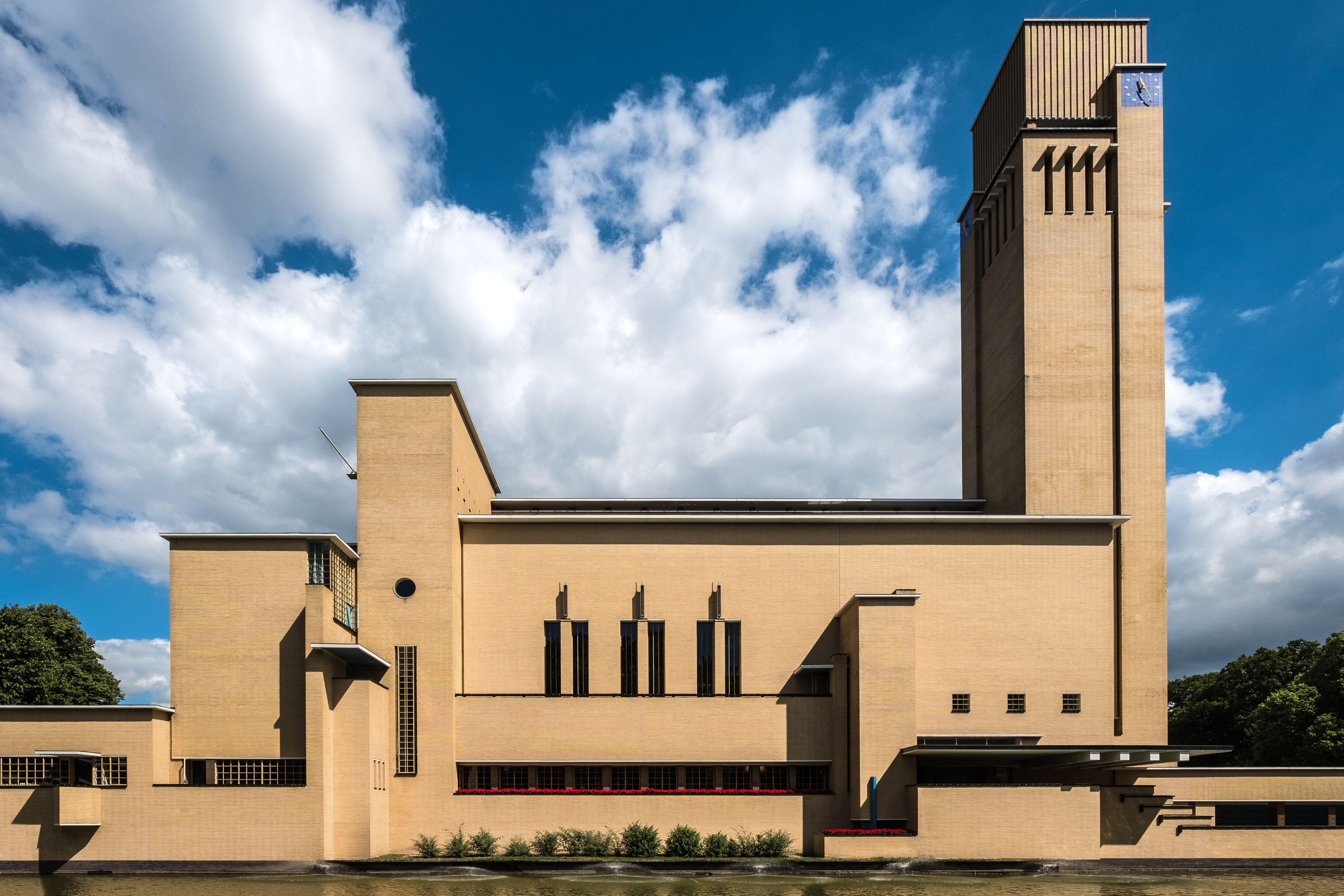 A modern building with a tall tower, rectangular windows, and a flat roof.