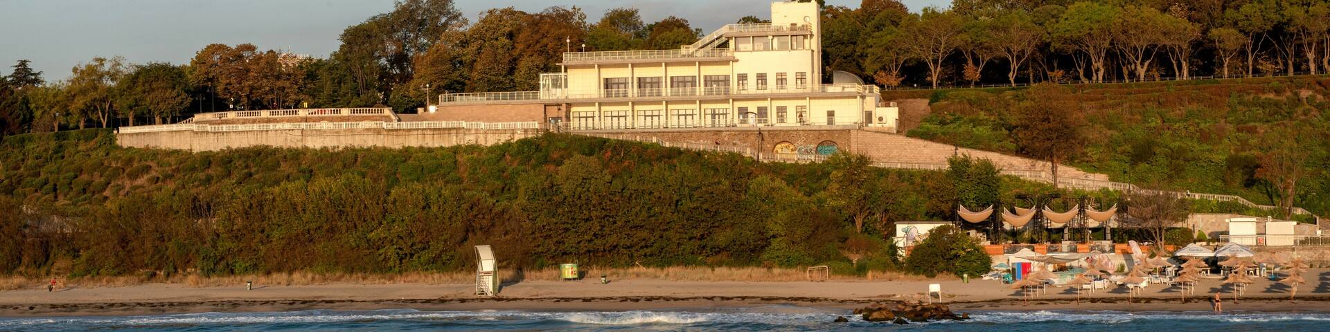 The iconic architecture of the Burgas Sea Casino building now a culture center overlooking the pier on the Black Sea coast of Burgas in Bulgaria .