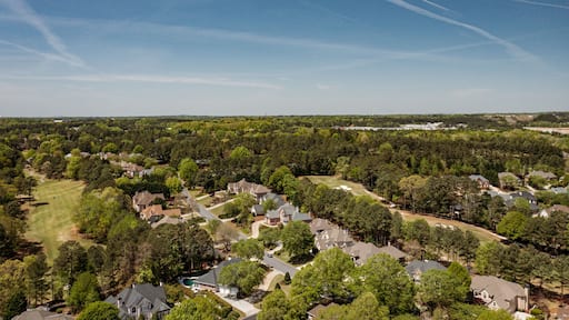Aerial panoramic view of house cluster in a sub division in Suburbs with golf course and lake in metro Atlanta in Georgia ,USA shot by drone shot during golden hour
