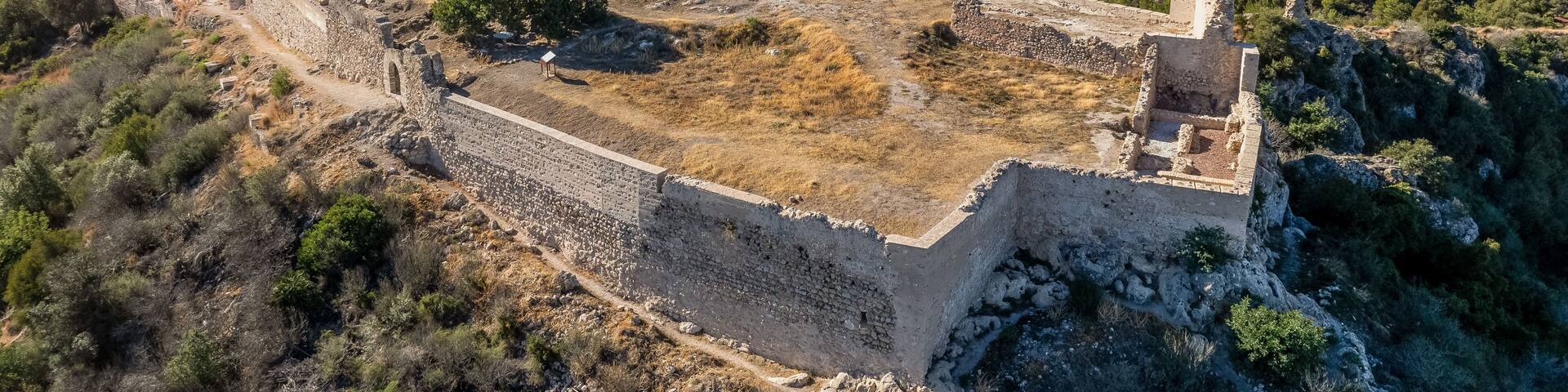 Aerial view of Bairen medieval castle ruin near Gandia in Spain with partially restored circular towers with cloudy sky