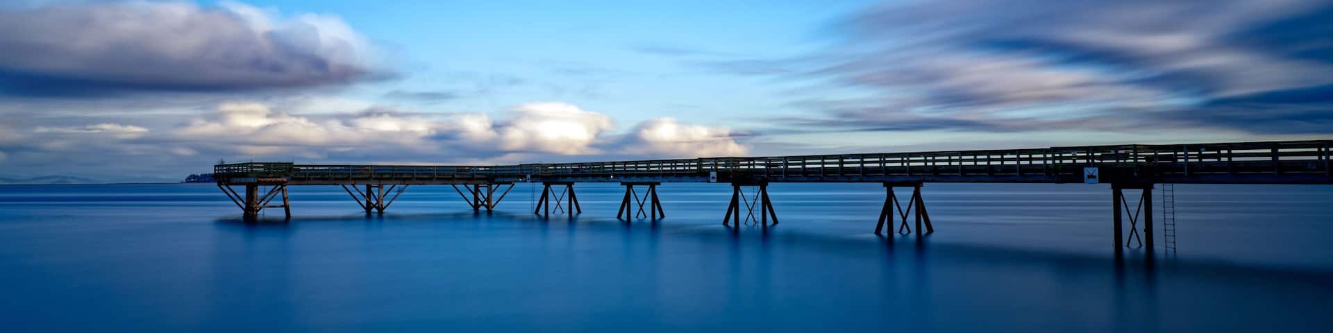 Wooden pier extending into the distance in Sidney Pier, Sidney, BC, Canada