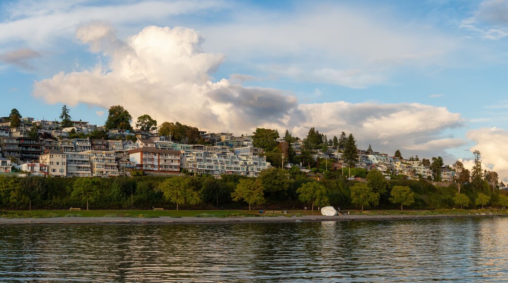 White Rock, British Columbia, Canada. Beautiful Panoramic View of Residential Homes on the Ocean Shore during a sunny and cloudy summer sunset.