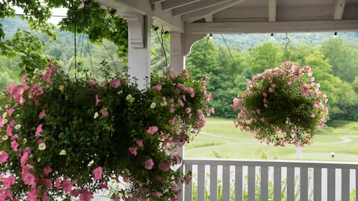 Hanging flowers on porch in Randolph, Vermont overlooking golf course