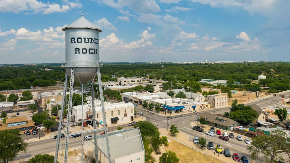Round Rock featuring a small town or village, signage and landscape views