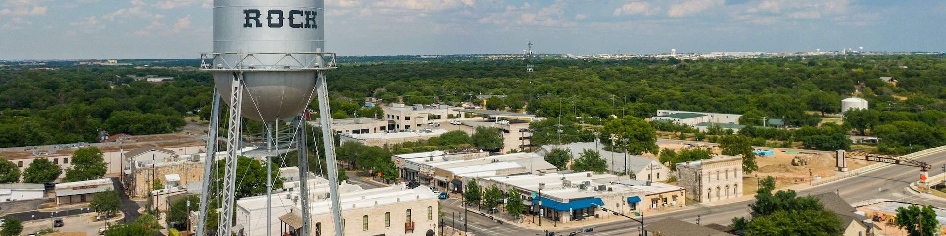 Round Rock featuring a small town or village, signage and landscape views