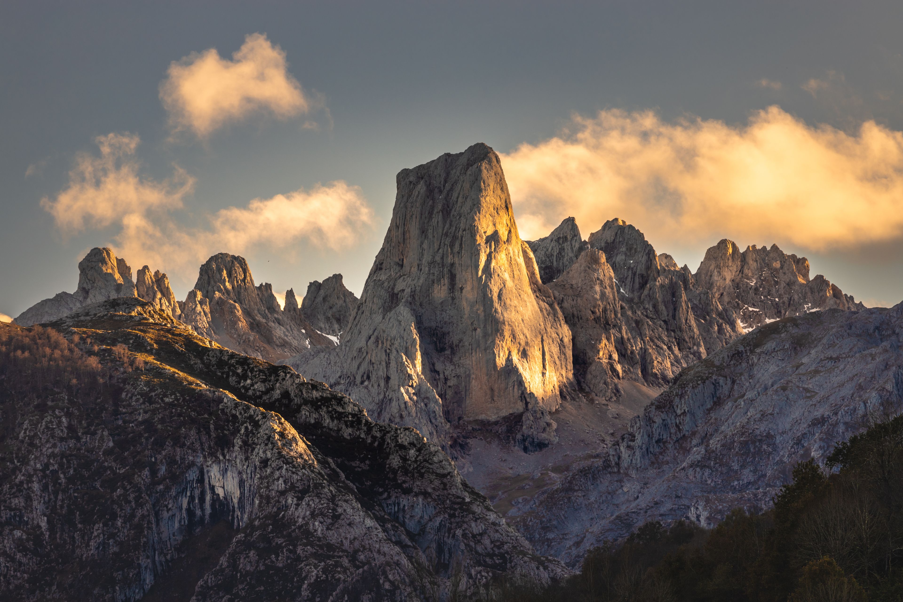 A mountain range with prominent peaks and a clear sky.