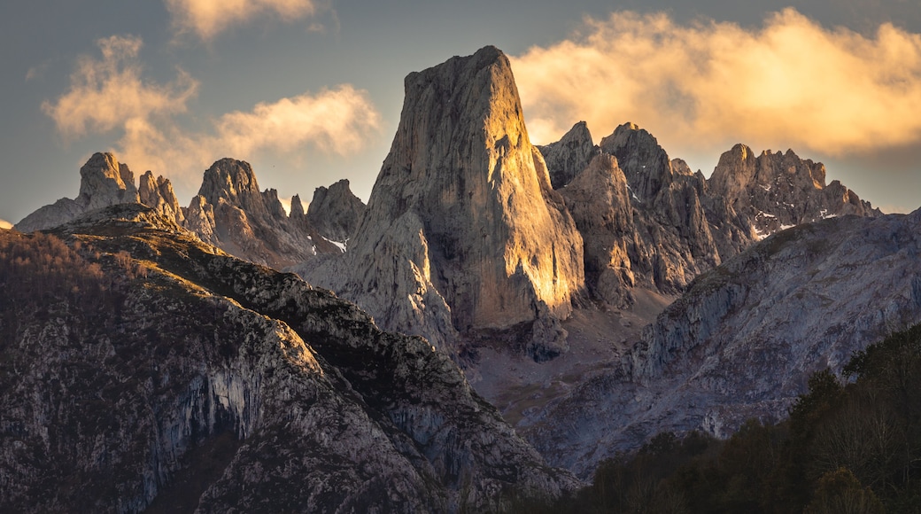 A mountain range with prominent peaks and a clear sky.