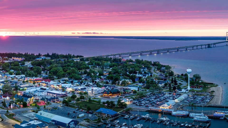 A coastal town with a large bridge, marina, and waterfront buildings.