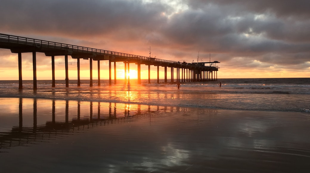 Sunset through Scripps Pier on the coastline of La Jolla California
