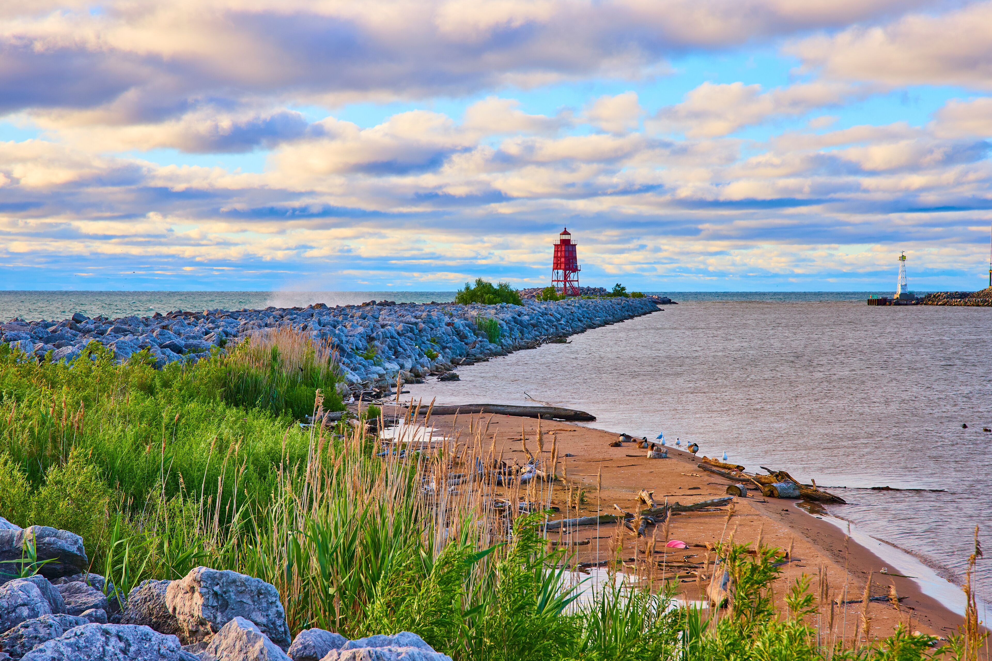 Racine Breakwater Lighthouse at Sunrise with Coastal Vegetation Eye-Level View