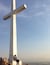 A large white cross monument with a person sitting at its base.