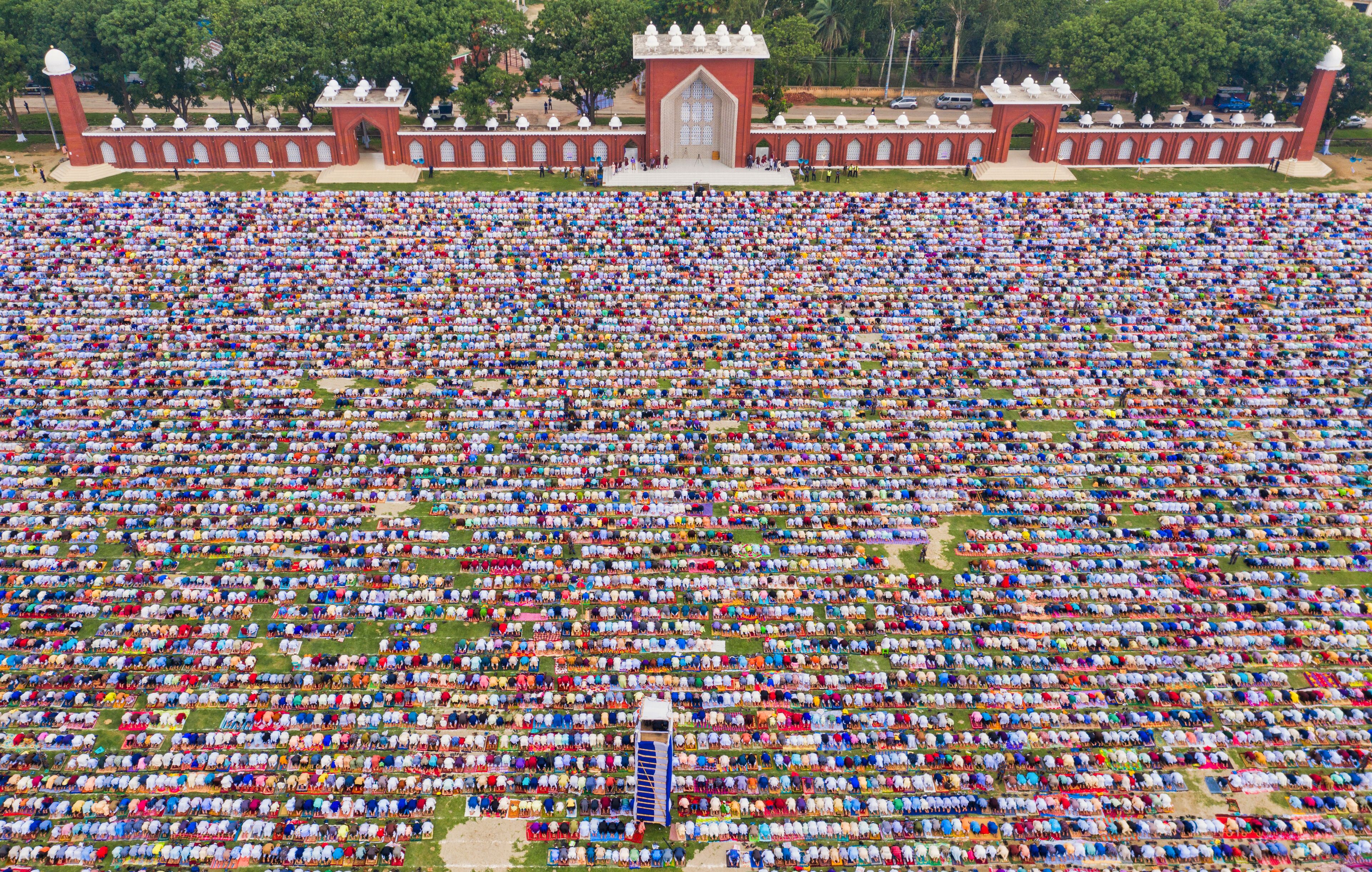 Aerial view of a vast crowd of people worshipping at Gore Shahid park in front of Eid Gah Minar religious site in Dinajpur, Rangpur, Bangladesh.