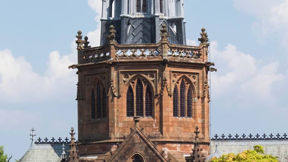 A Gothic-style church with a tall spire and intricate stonework.
