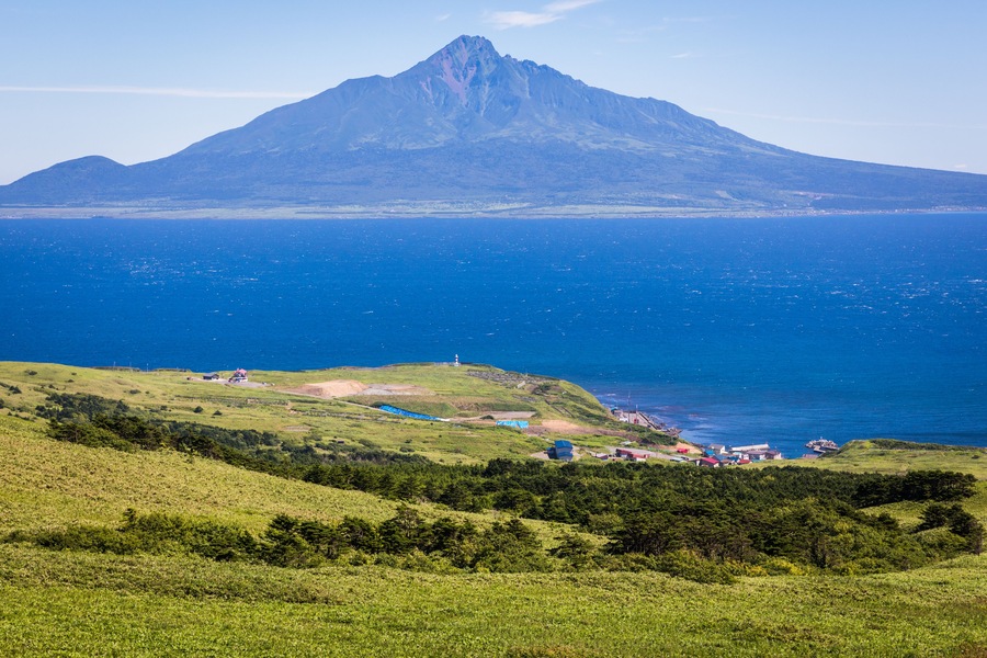 Rolling hills of sasa bamboo grass and wildflowers cover the southern tip of Rebun Island, Japan, village of Shiretokomanai and Mt. Rishiri are in the distance, Shutterstock ID 760781635, Purchase Ord