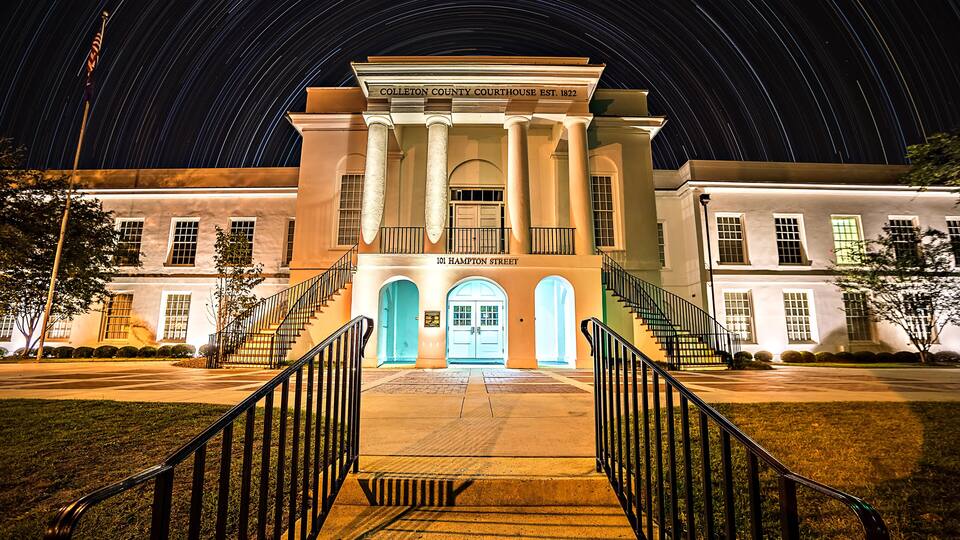 The Colleton County Courthouse with a night sky filled with star trails.