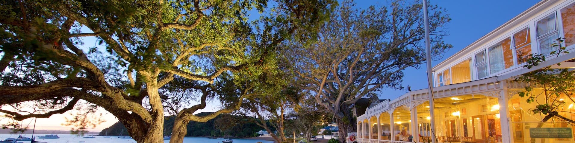 Russell featuring cafe lifestyle, a sunset and a bay or harbor