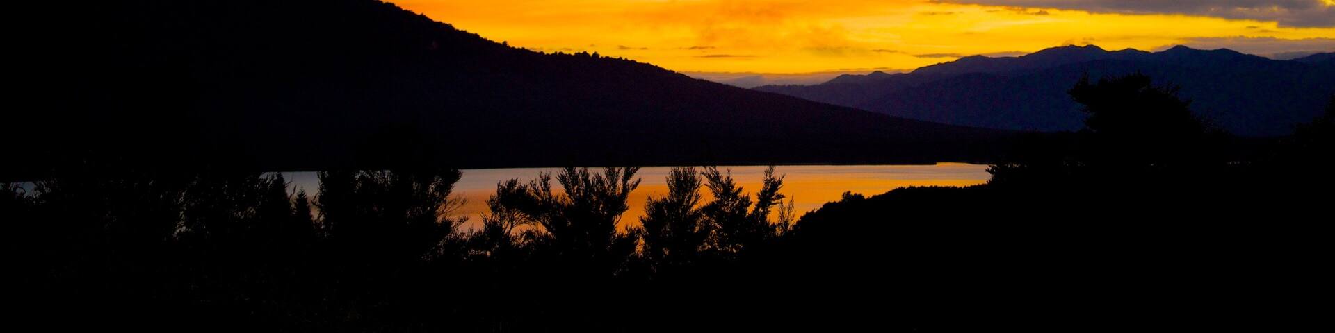 Turangi which includes landscape views and a sunset