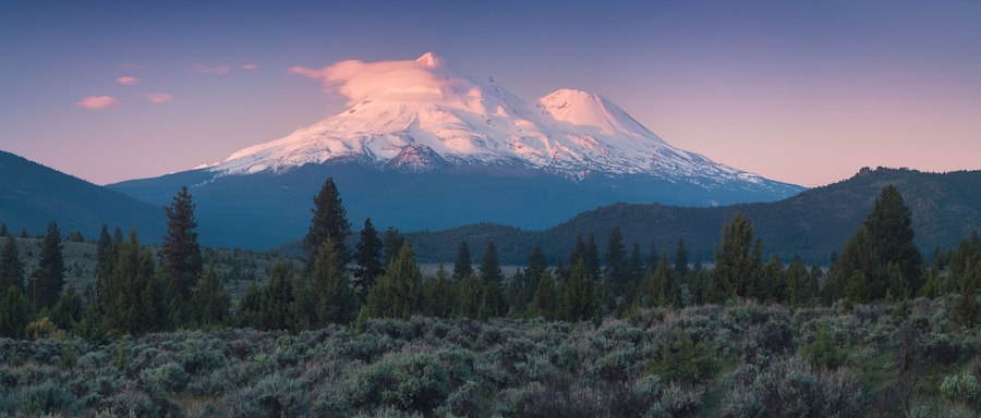View of Mount Shasta Volcano with glaciers, in California, USA. Panorama from north. Mount Shasta is a potentially active volcano at the southern end of the Cascade Range in Siskiyou County
