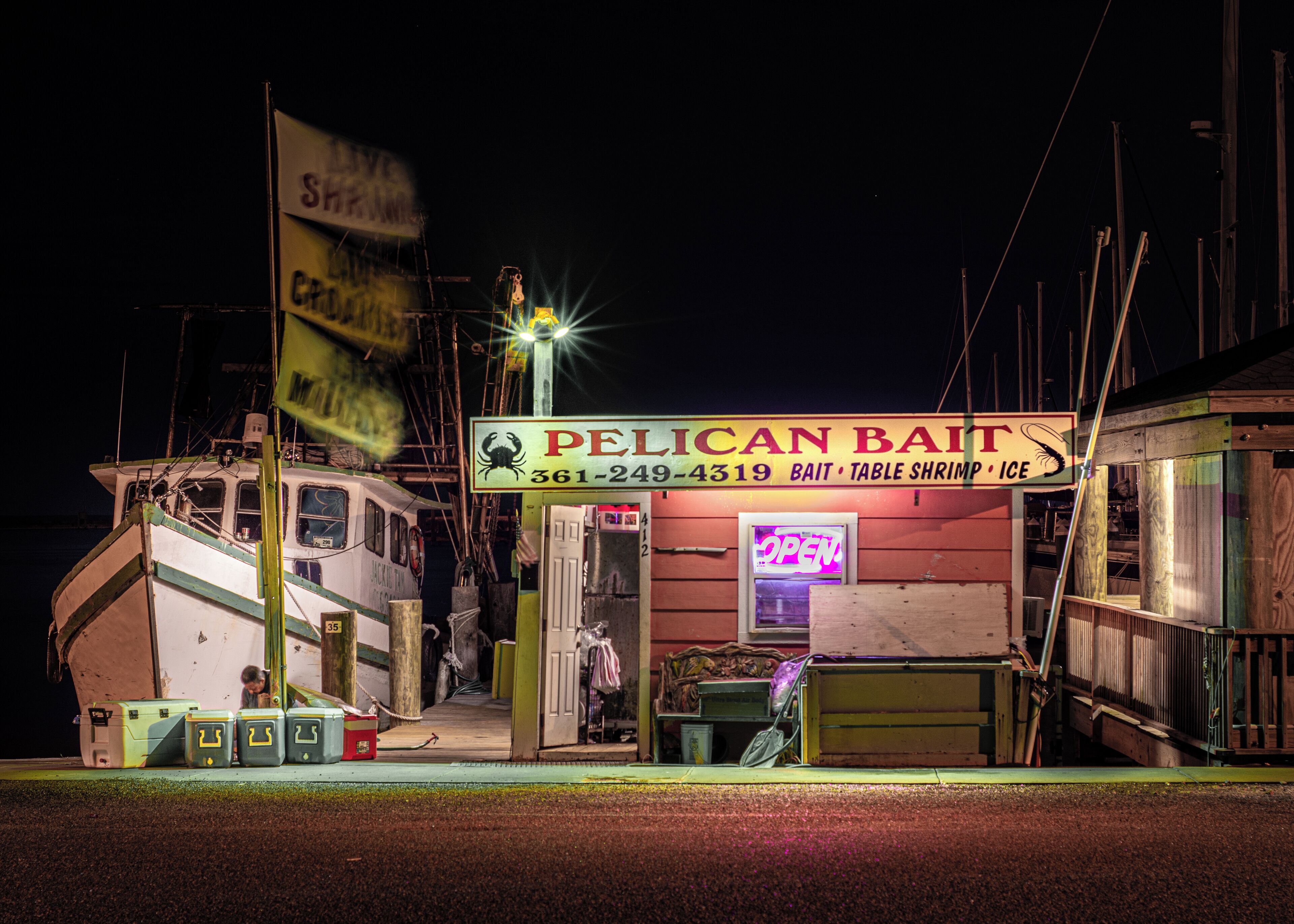 Walking around the marina late one evening in Rockport and saw this fun little bait house. 