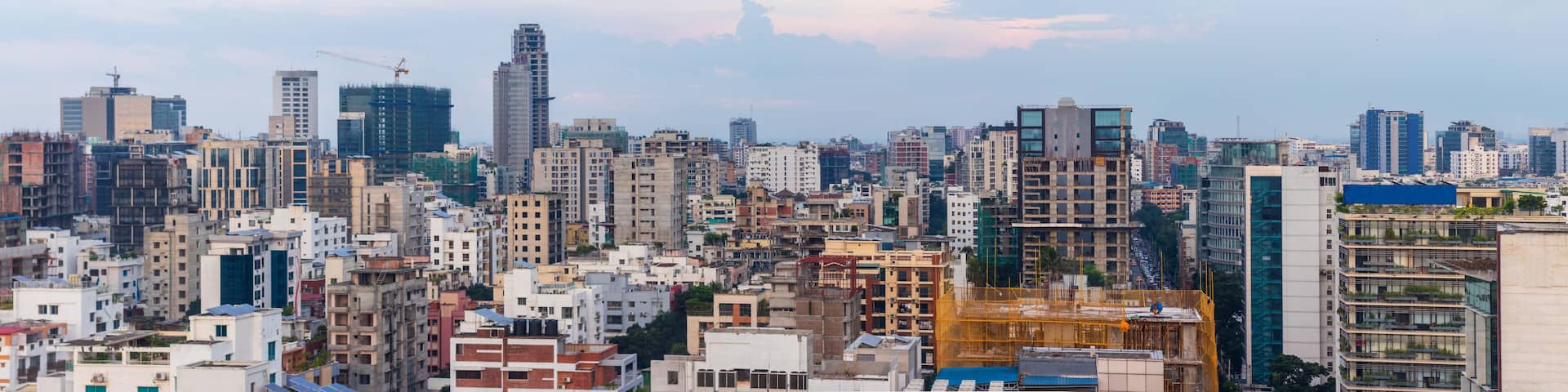 A densely packed urban skyline with a variety of building styles, including modern high-rises and older, lower-rise structures.