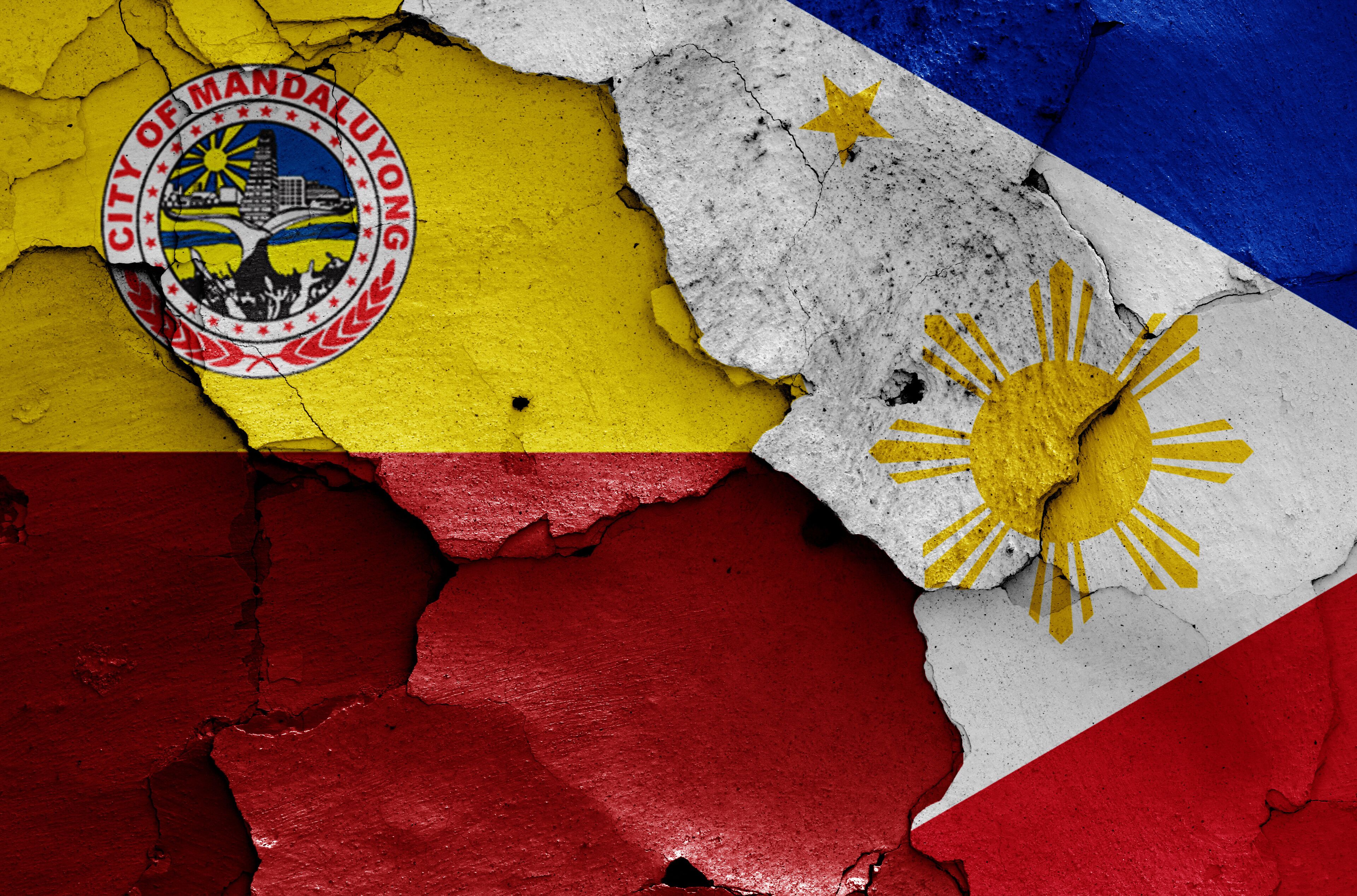 flags of Mandaluyong and Philippines painted on cracked wall