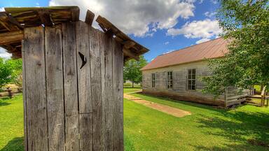 Pioneer School Outhouse Pioneer Heritage Homestead Doniphan Missouri Old outhouse next to the school.