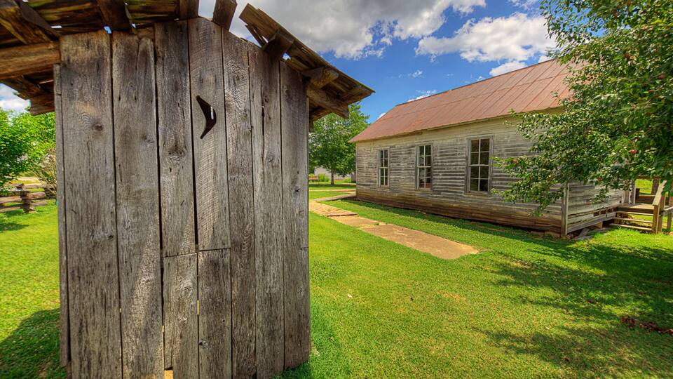 Pioneer School Outhouse Pioneer Heritage Homestead Doniphan Missouri Old outhouse next to the school.