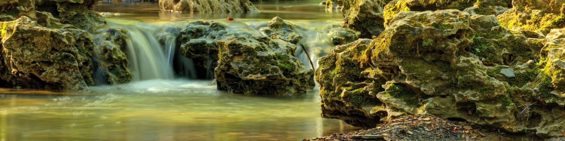 A beautiful stream runs along a scenic drive that leads to the Canopy Tree Walk, an bridge.
