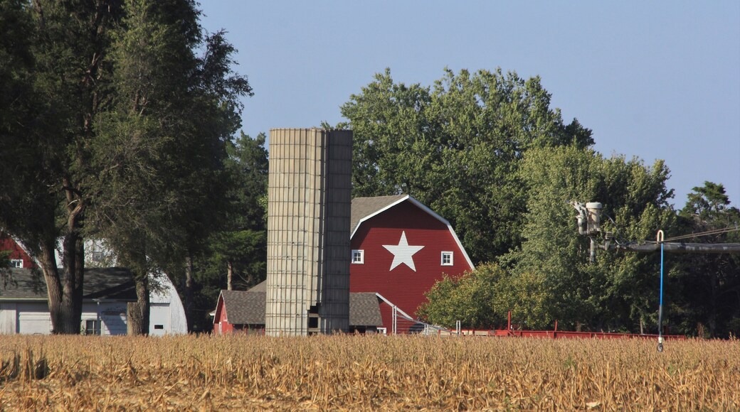 red barn in the countryside with blue sky and a white star on the barn. South of Sterling Kansas USA out in the country.