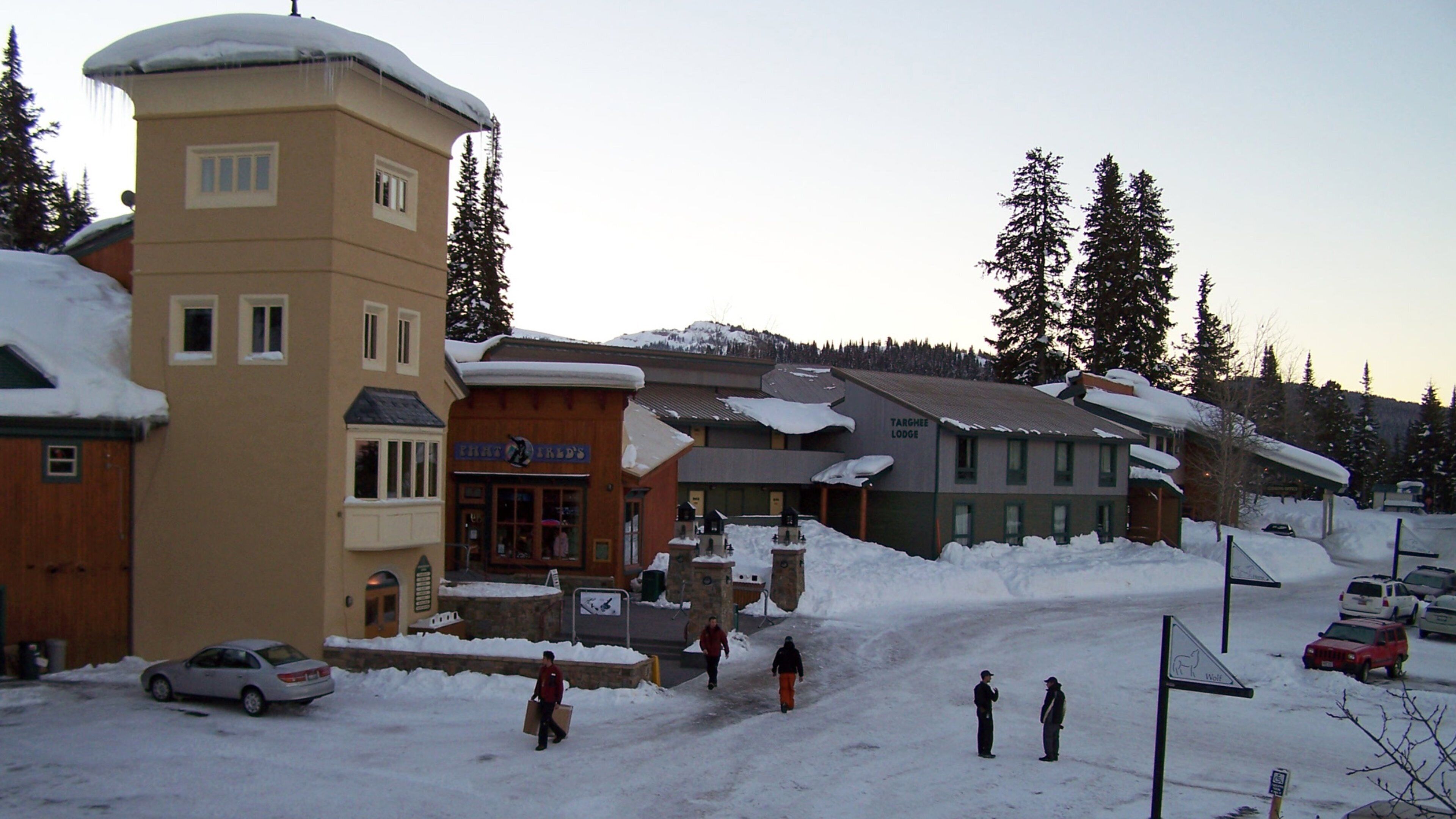 A snowy village with buildings, a tower, and a sign for 'Targhee Lodge'.
