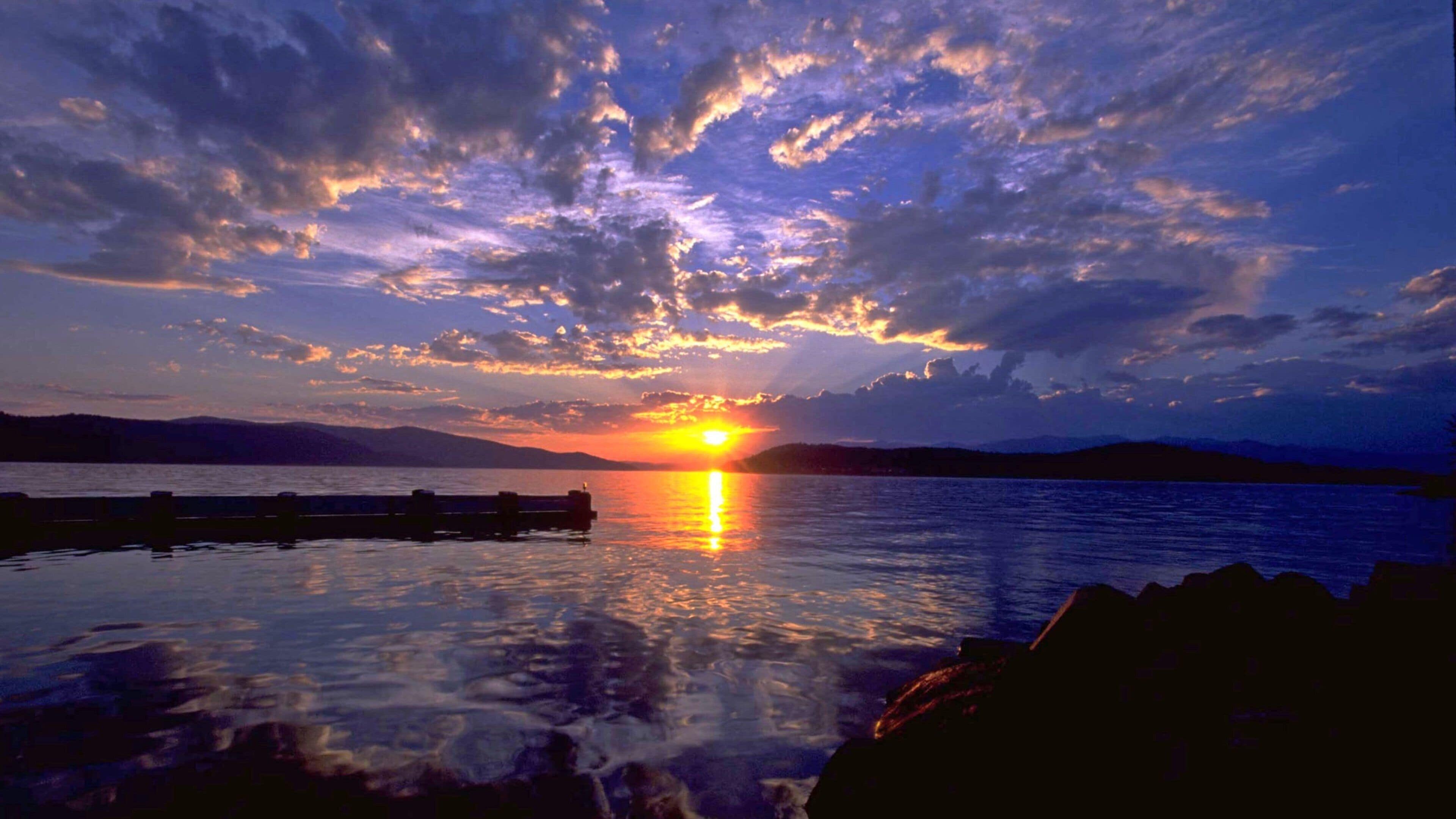 Sandpoint featuring a lake or waterhole and a sunset