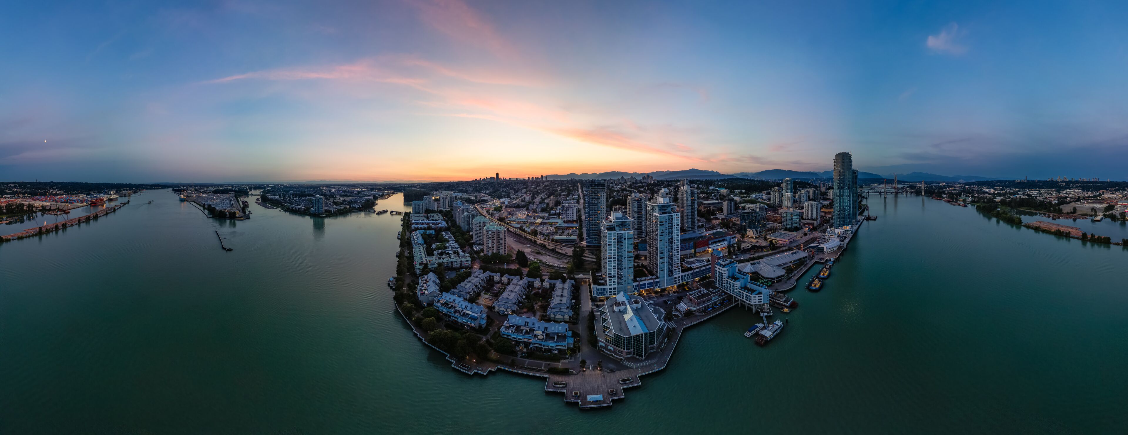 Panoramic View of City Buildings by river at twilight. New Westmister, Vancouver, BC, Canada. Aerial