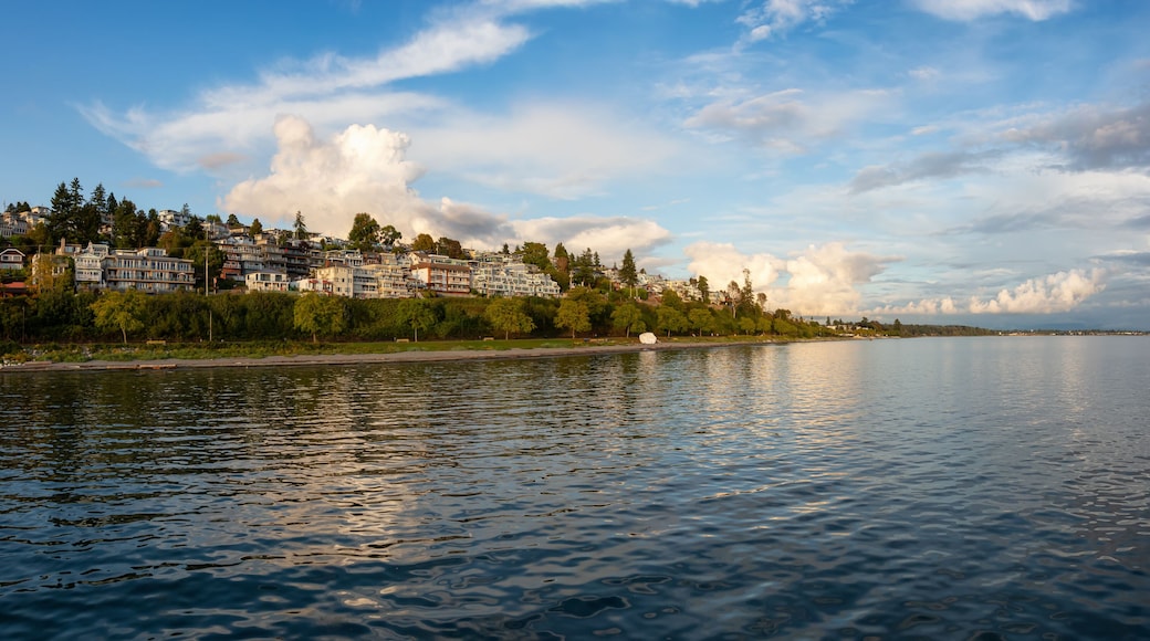 White Rock, British Columbia, Canada. Beautiful Panoramic View of Residential Homes on the Ocean Shore during a sunny and cloudy summer sunset.