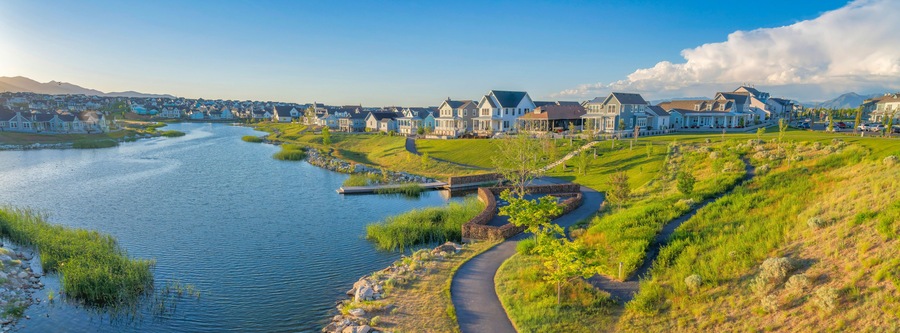 Oquirrh Lake at Daybreak residential community with concrete pavements on the side