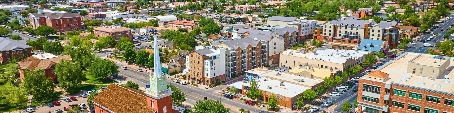 Aerial Historic Red Brick Church Downtown St George Utah with Red Rock Mesas