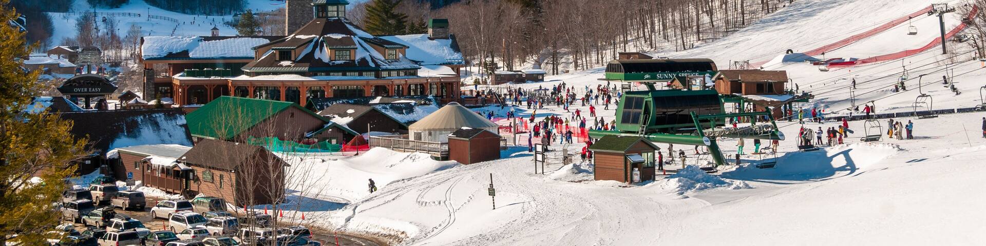 Spruce Peak Lodge in the winter with Mt. Mansfield in the background, Stowe, Vermont, USA
