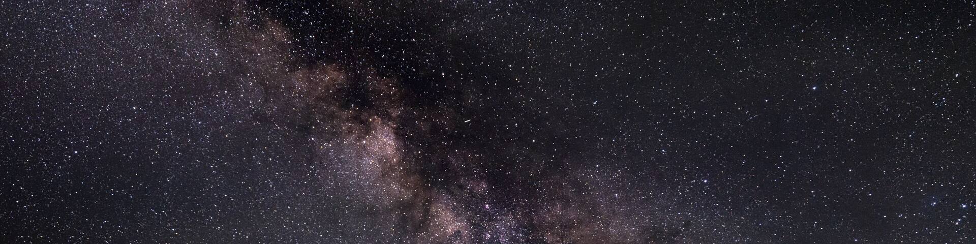 Milkyway galaxy leading down to old red barn in rural Gunnison County, Colorado