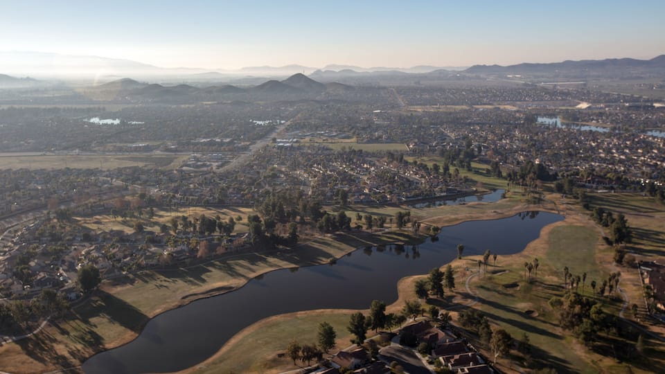 Daytime aerial view from hot air balloon of housing in Menifee Lakes southern California United States