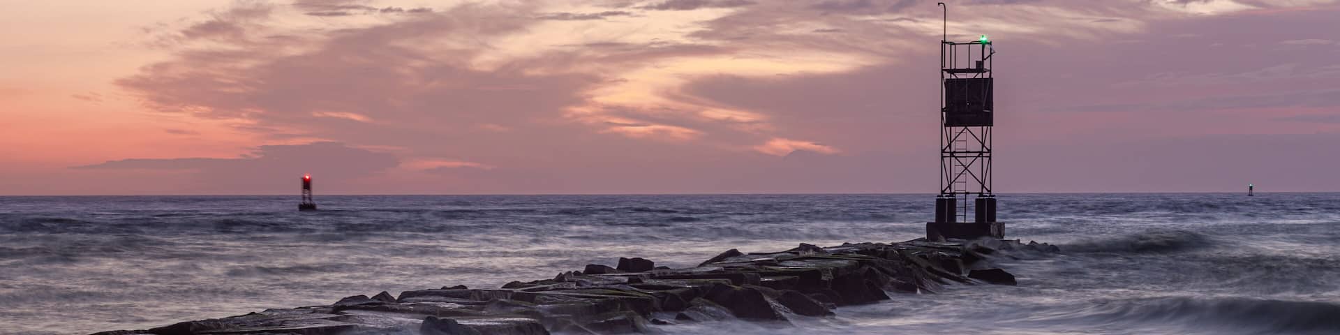 Ocean Beach Breakwater with Sunrise and Waves with Colorful Sky