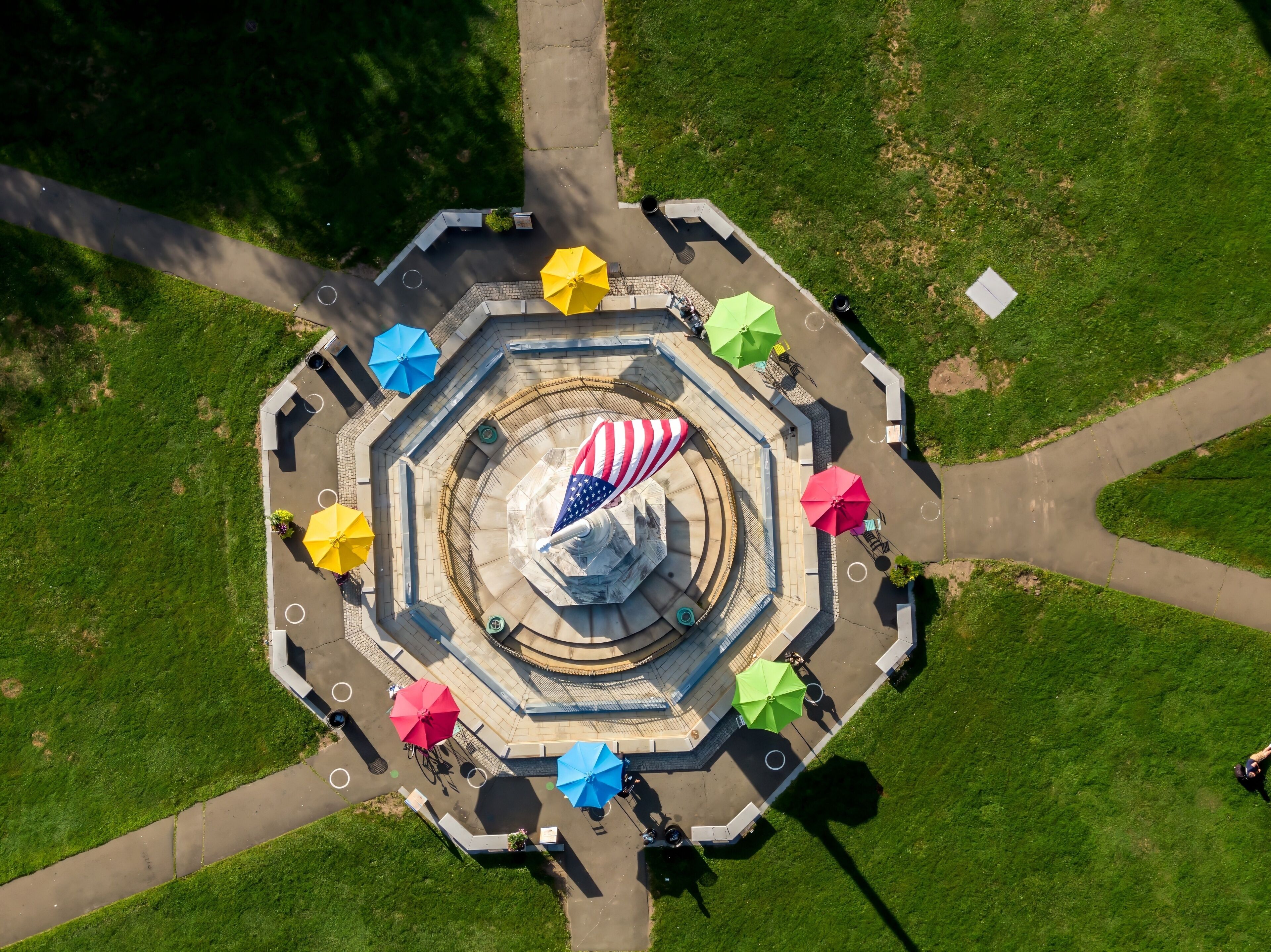 Umbrellas and american flag on the New Haven Green, New Haven, Connecticut, United States.